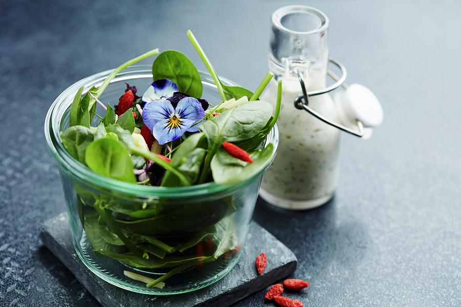Spinach Salad With Goji Berries, Pansies, And A Yogurt Dressing Photograph by Liv Friis