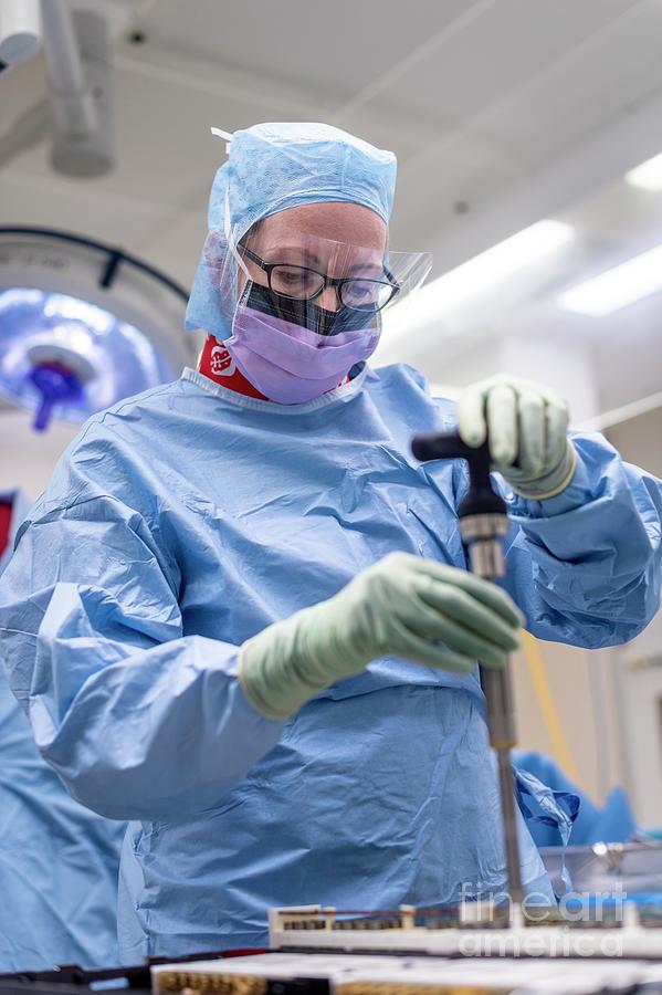 Spinal Surgeon Preparing Tool Photograph by Jim Varney/science Photo Library