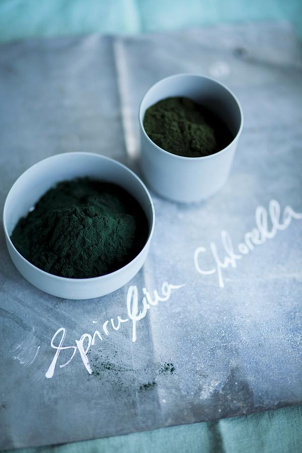 Spirulina And Chlorella Powder In Small Bowls Photograph by Eising Studio