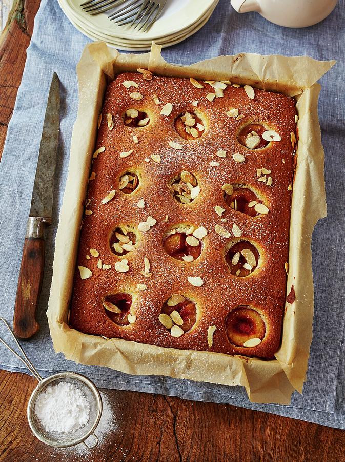 Sponge Cake With Plums And Almonds Photograph by Clive Streeter