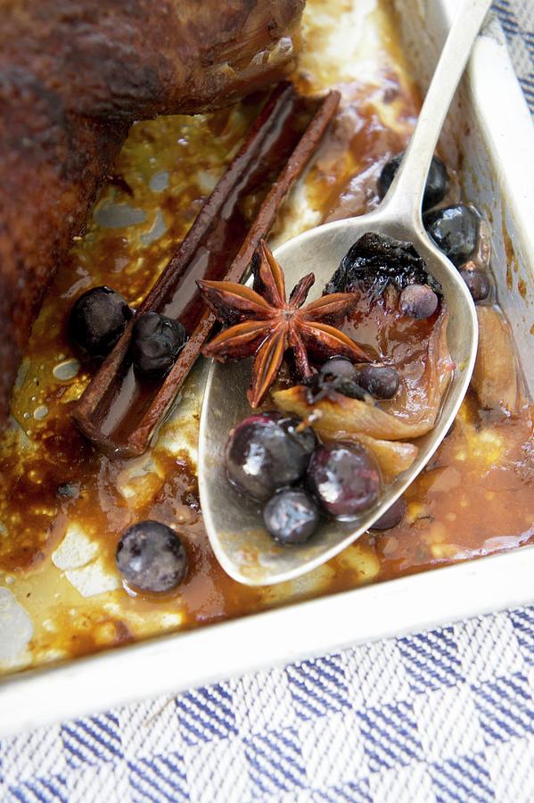 Spoon With Gravy, Sloes, Cinnamon And Star Anise Photograph by Martina Schindler