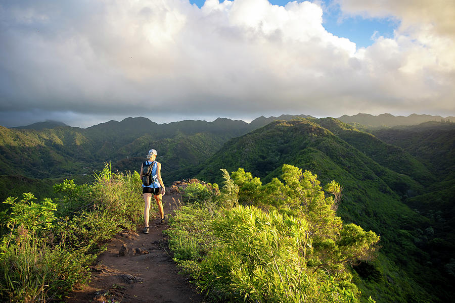 Mountain Photograph - Sporty Woman Hiking A Narrow Trail Atop A Hawaiian Mountain Range by Cavan Images