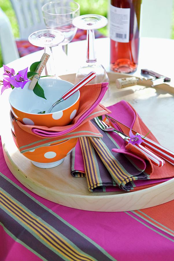 Spotty Bowls, Colourful Fabric Place Mats And Striped Cutlery On Wooden Tray In Garden Photograph by Matteo Manduzio
