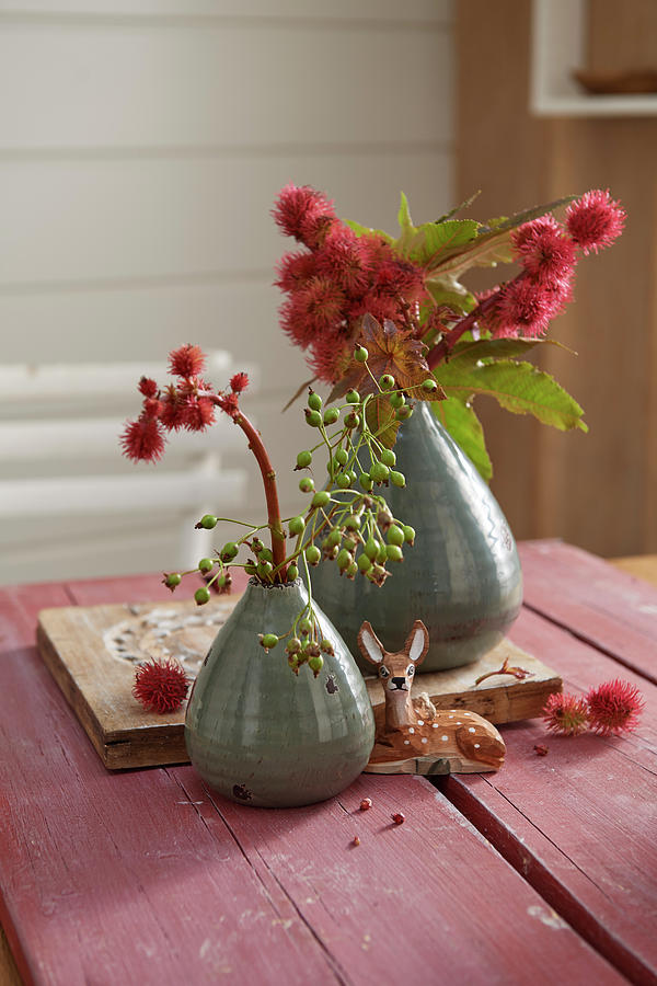 Sprigs Of Red Flowers In Vases And Deer Figurine Photograph by Stockfood Studios / Jan-peter Westermann