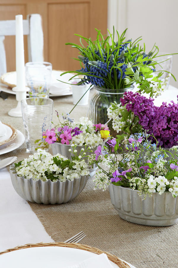 Spring Flowers In Vintage Cake Tins Decorating Table Photograph by Simon Scarboro