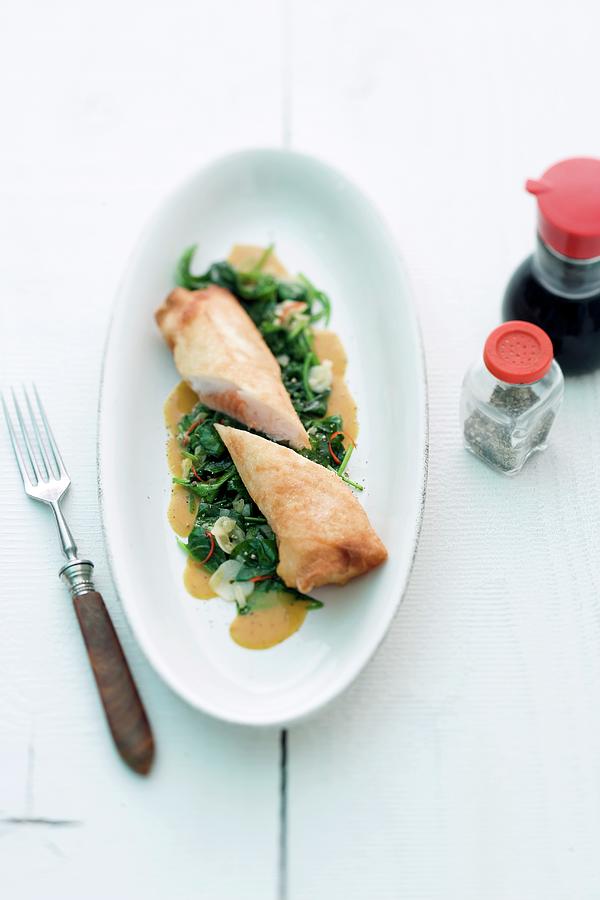 Spring Rolls With A Salmon Filling On A Chard Medley Photograph by Michael Wissing