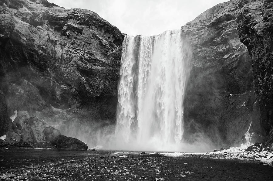 Springtime Snow Melting at Base of Grand Skogafoss Waterfall Iceland Black and White Photograph by Shawn OBrien