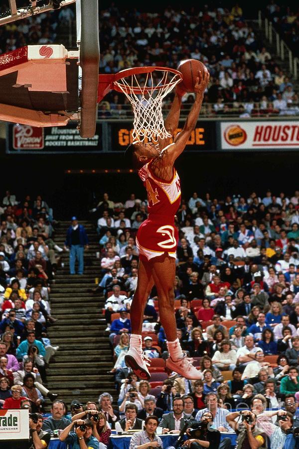 Spud Webb jumping over a kid at his - Basketball Network