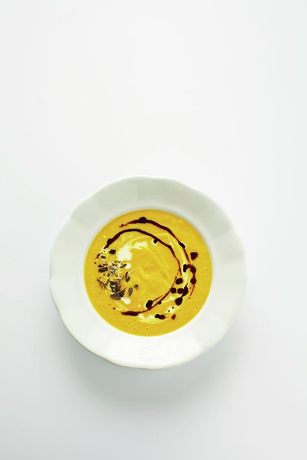 Squash Soup With Pumpkin Seed Oil Photograph by Herbert Lehmann
