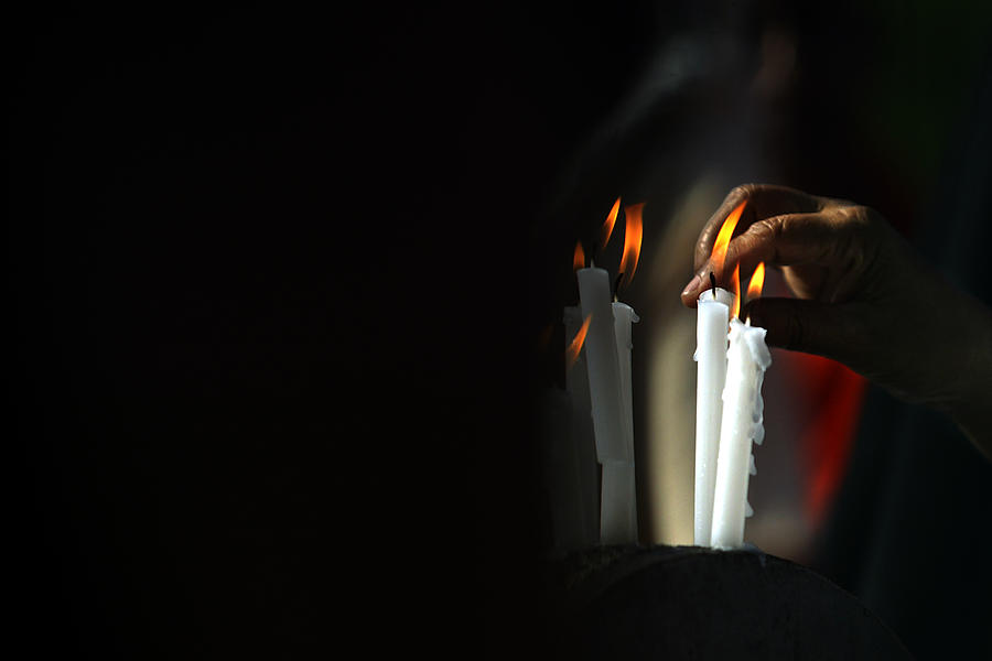 Sri Lankan Man Lights a Candle Photograph by Arko Datta Fine Art America