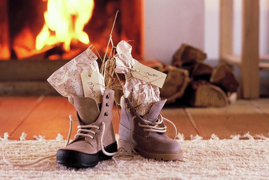 St. Nicholas Gifts With Name Tags In Laced Boots In Front Of Open Fire Photograph by Peter Kooijman