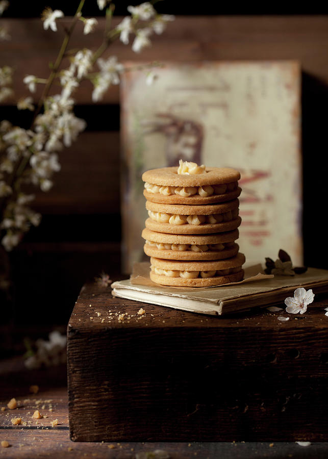 Stack Of Buttercream Filled Biscuits In A Rustic Setting Photograph by Jane Saunders