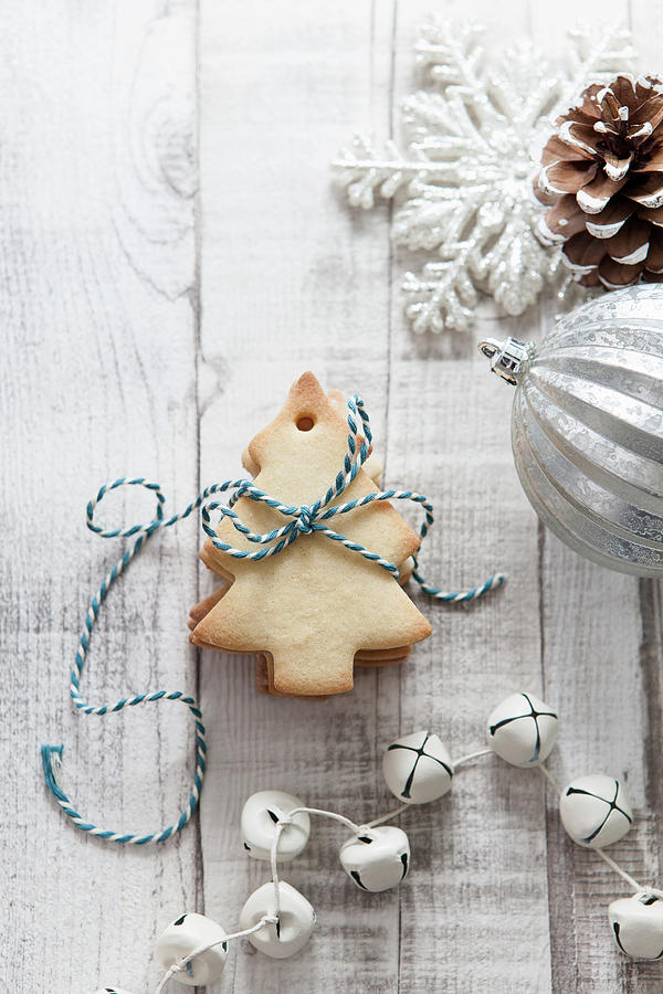 Stack Of Christmas Tree Shaped Biscuits Tied With Blue And White Bakers Twine On A White Wood Rustic Christmas Setting Photograph by Stacy Grant