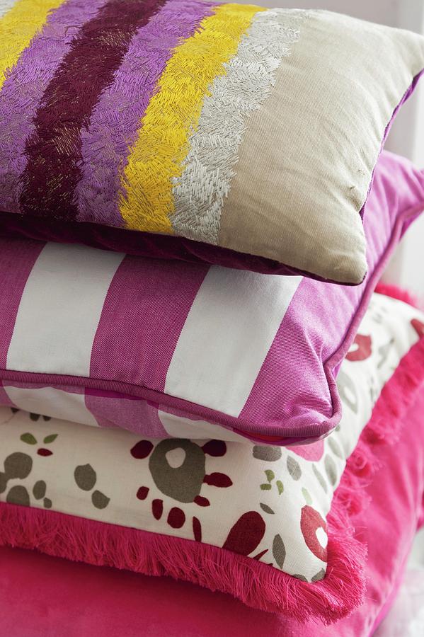 Stack Of Decorative Pillows In Assorted Pink And Purple Fabrics Photograph by Anthony Lanneretonne