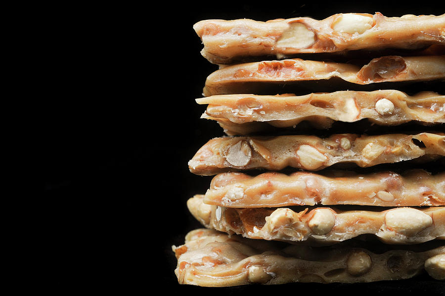 Stack Of Peanut Brittle On A Black Background close-up Photograph by Clarke Cond