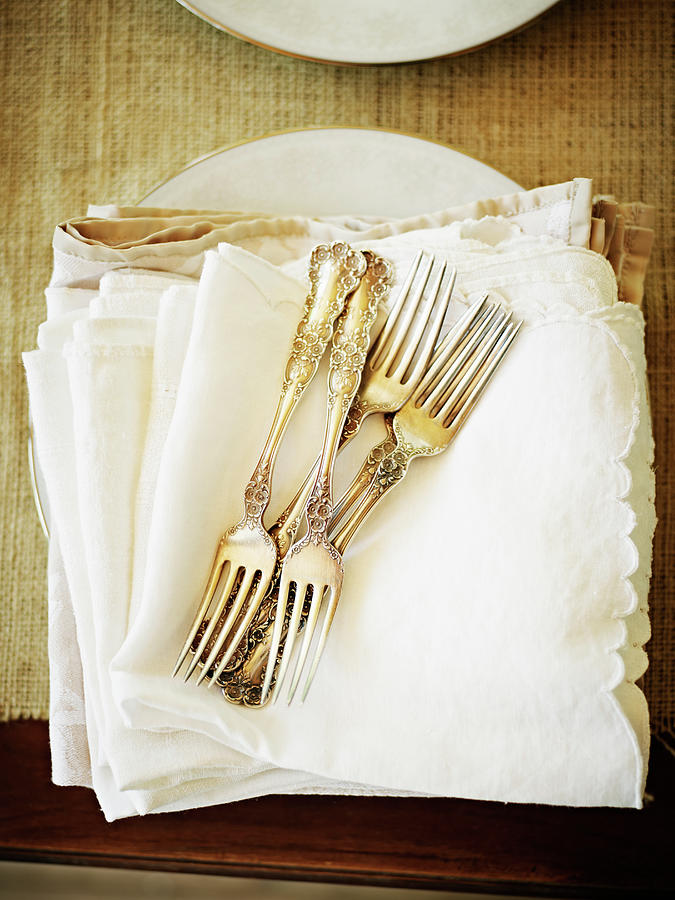 Stack Of Silver Forks And Napkins Photograph by Thomas Barwick