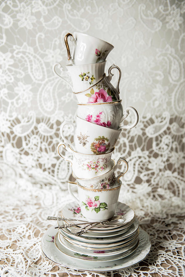 Stack Of Vintage Cups And Plates With Floral Motifs Photograph by Ruud Pos