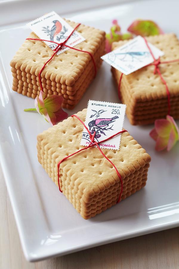 Stacked Biscuits Tied Together & Decorated With Postage Stamps Photograph by Franziska Taube