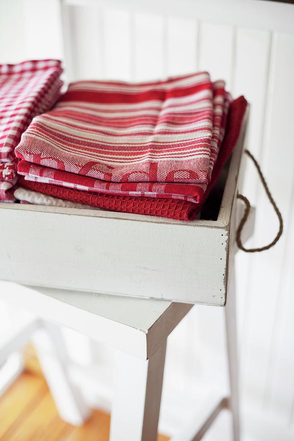 Stacked Dish Towels In A White Vintage Box On A Stool Photograph by Great Stock!