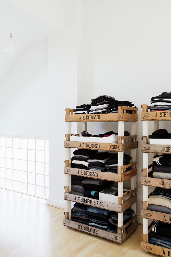 Stacked Fruit Crates Used As Creative Shelves For Clothing In Loft-style Bedroom Photograph by Rikard Osterlund