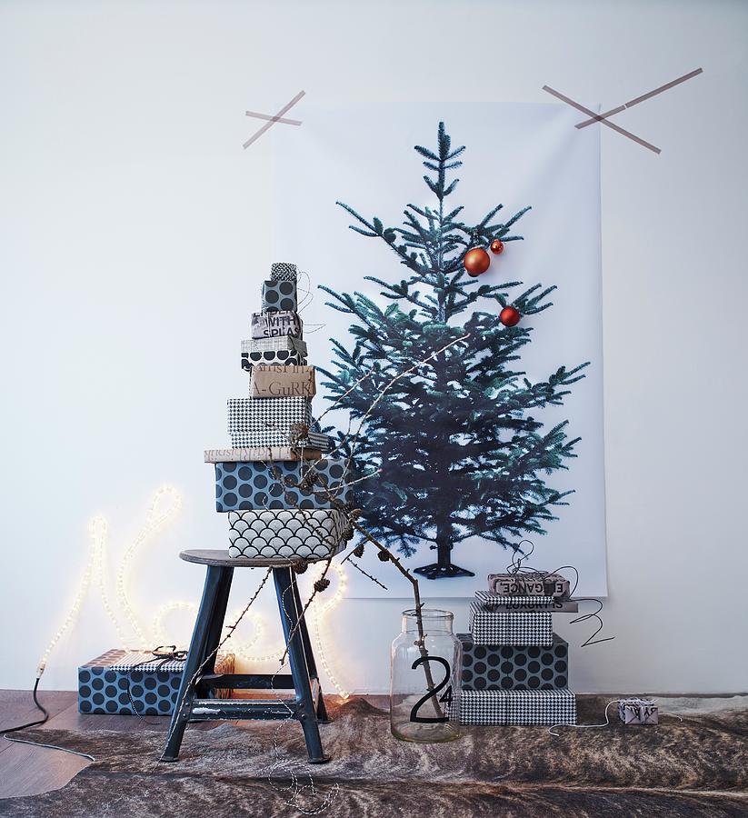 Stacked Gifts Wrapped In Black And White Paper Below Christmas Tree Print On Wall Photograph by Andreas Hoernisch