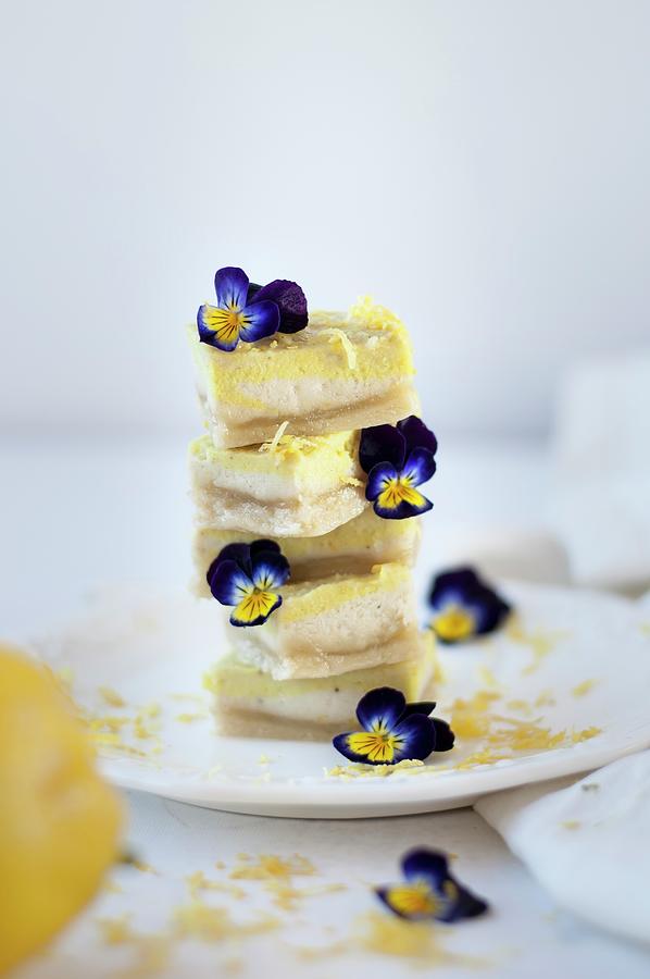 Stacked Lemon Slices Decorated With Horned Violets Photograph by Healthylauracom