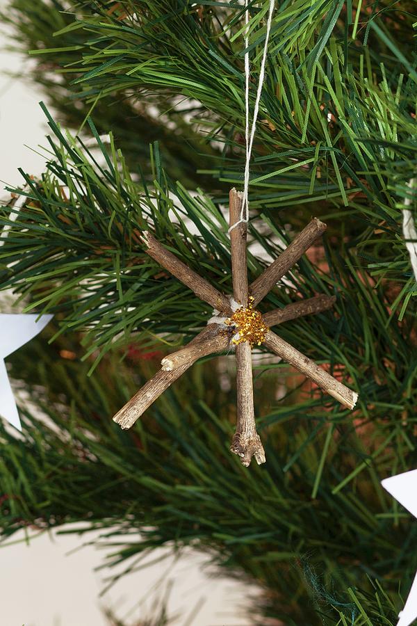 Star Made From Twigs Hanging On Christmas Tree Photograph by Great Stock!