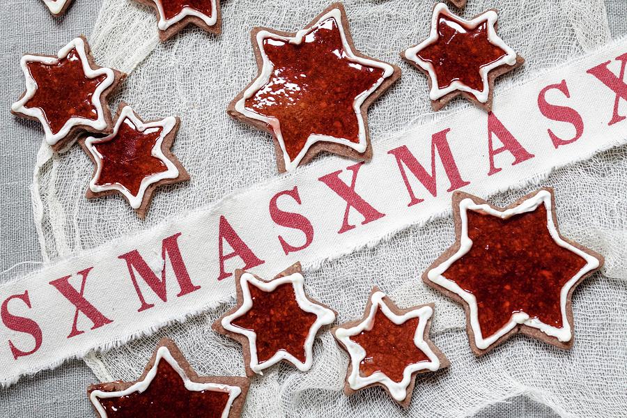Star Shaped Almond Biscuits Filled With Redcurrant Jelly With Christmas Decorations Photograph by Susan Brooks-dammann