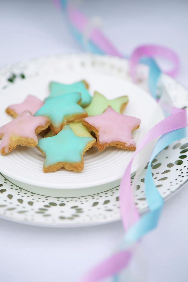 Star-shaped Biscuits Decorated With Pastel-coloured Icing Sugar For A Baptism Party Photograph by Winfried Heinze