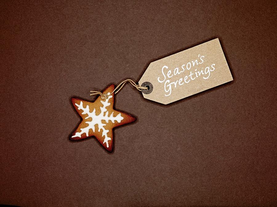 Star Shaped Ginger Bread Biscuit With White Icing, And Christmas Gift-tag, On A Brown Background Photograph by Will Shaddock Photography