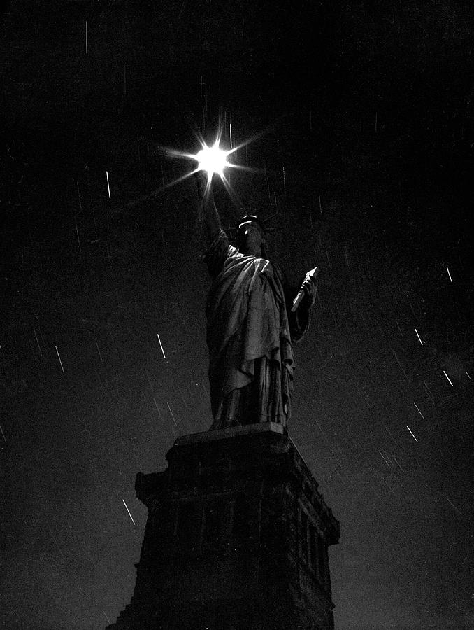Statue Of Liberty At Night Photograph by Andreas Feininger