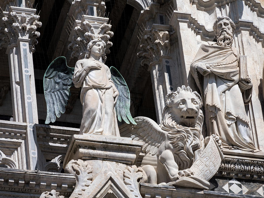 Statues of angel, lion and philosopher at Siena Cathedral Photograph by Tosca Weijers