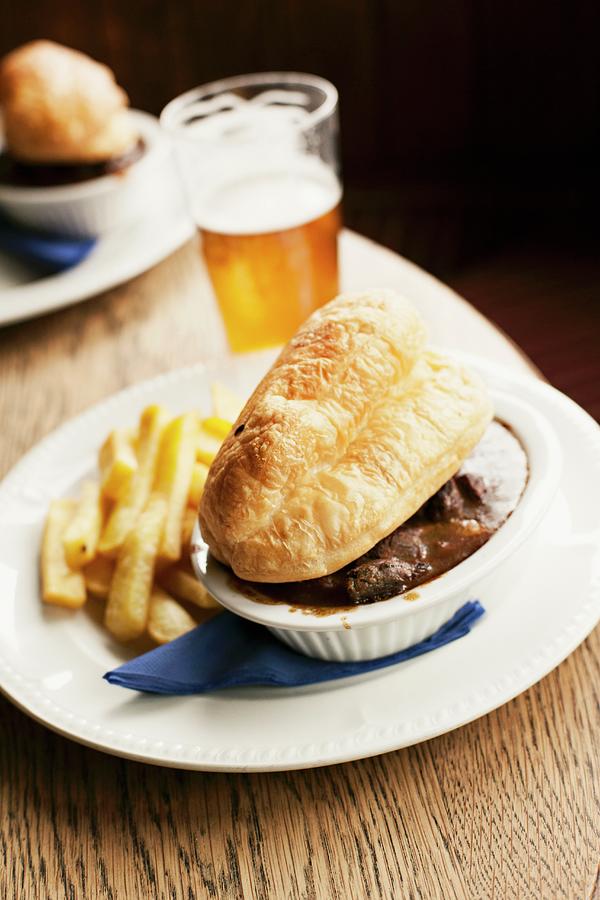 Steak And Ale Pie Served With Chips And A Glass Of Ale Photograph by Alex Hinchcliffe