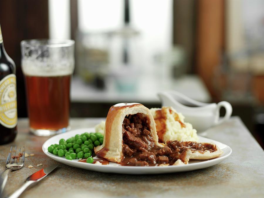 Steak And Kidney Pudding With Peas Photograph by Ian Garlick