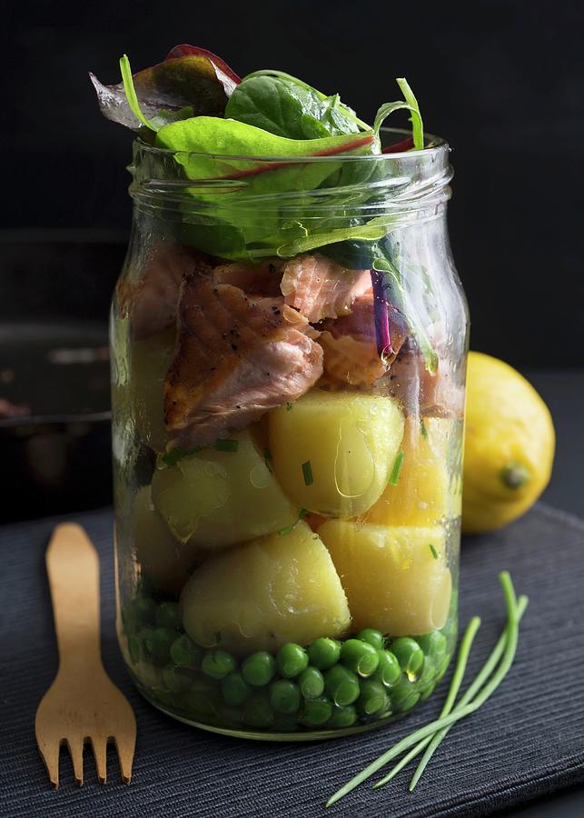 Steamed Salmon And Potatoes In A Glass Jar With Peas And Chard Photograph by Etienne Voss