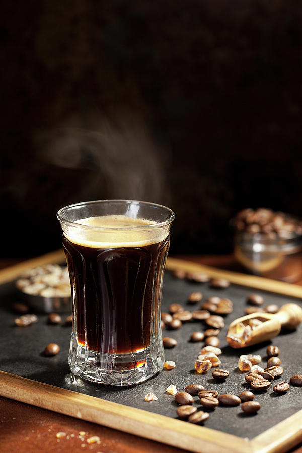 Steaming Black Coffee With Coffee Beans Photograph by Jane Saunders