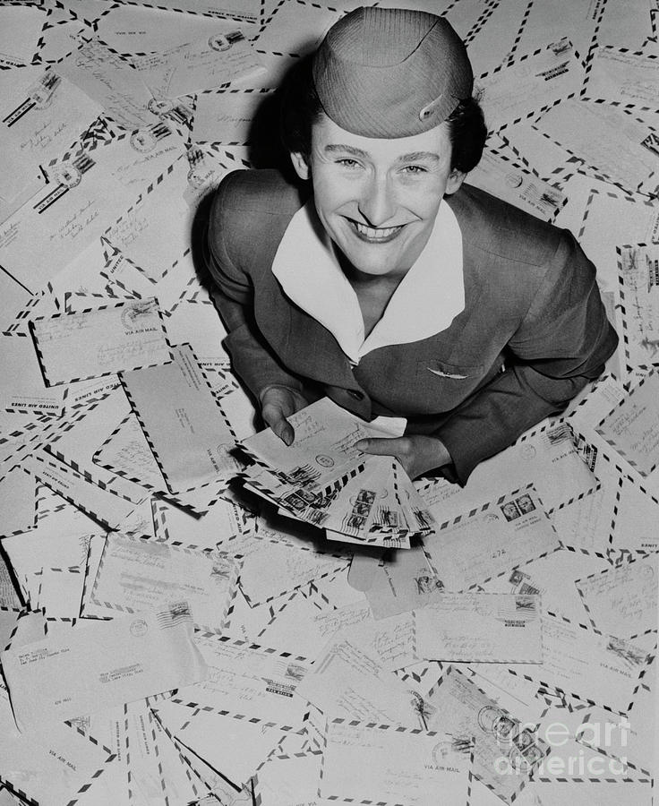 Stewardess Posing With Letters by Bettmann