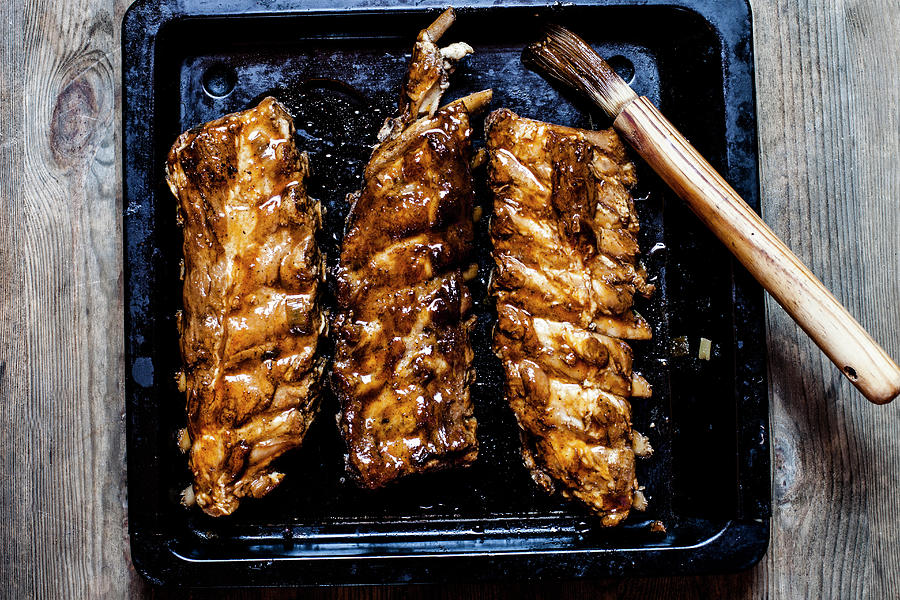 Sticky Spareribs With Homemade Bbq Glaze On A Oven Tray Photograph by Susan Brooks-dammann