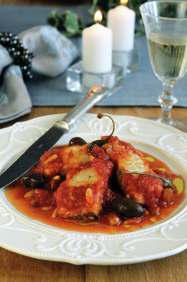 Stockfish In Tomato Sauce With Raisins, Pine Nuts And Capers Photograph by Mario Matassa