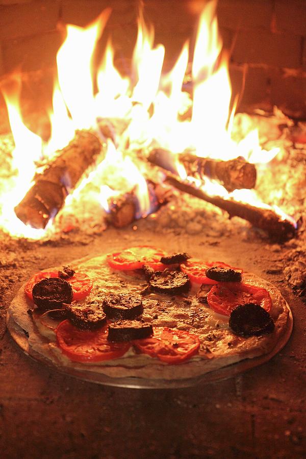 Stone-baked Pizza With Cheese, Tomatoes And Black Pudding In A Woodfired Oven Photograph by Lee Parish