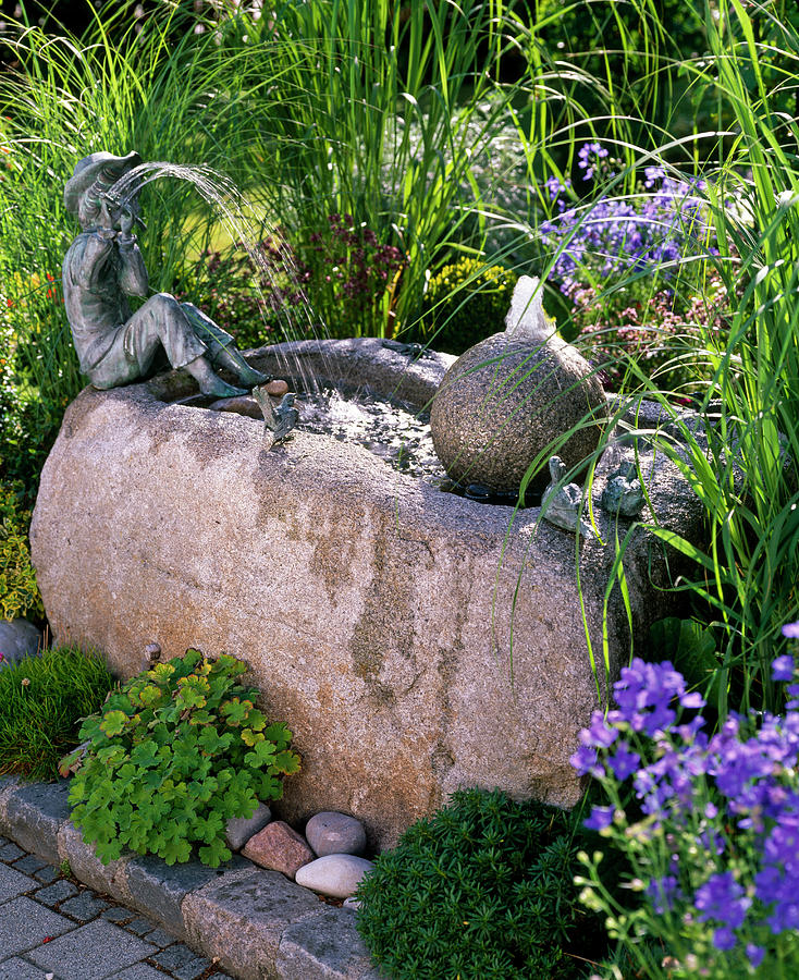 Stone Trough With Ball And Flute Player As A Water Feature Photograph by Friedrich Strauss
