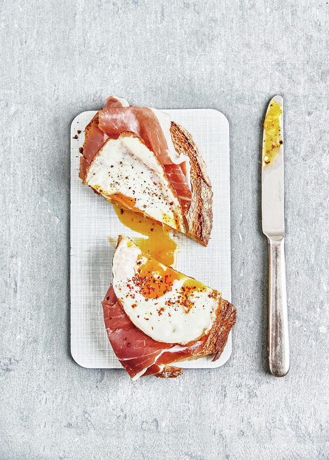 Strammer Max sourdough Bread With Raw Ham, Fried Egg, Pepper And Chilli Flakes Photograph by Sylvia Meyborg