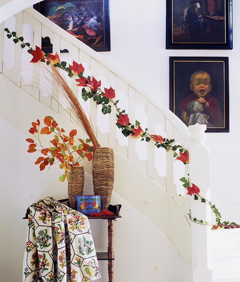 Strand Of Ivy And Red Autumn Leaves Twining Up Staircase Balusters Photograph by Matteo Manduzio