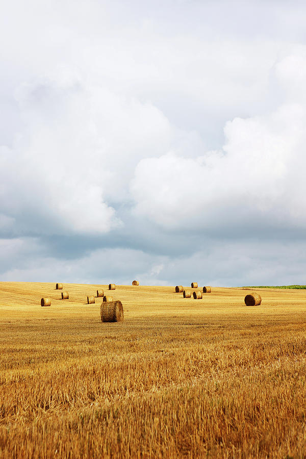 Straw Bales In Field With Stormy Sky Photograph by John Slater