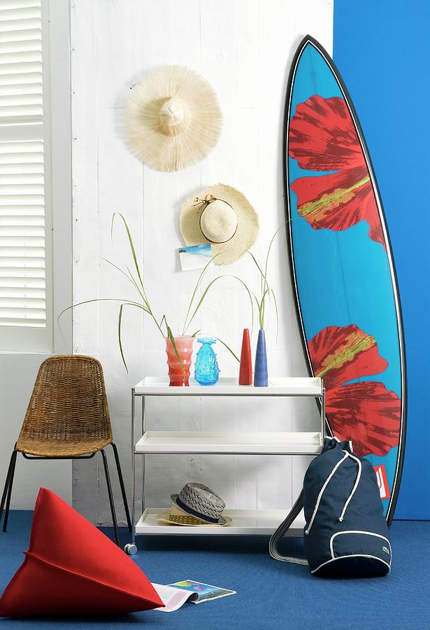 Straw Hats Hanging On Wall & Surfboard Leaning On Wall Next To Vases On Hall Table Photograph by Matteo Manduzio