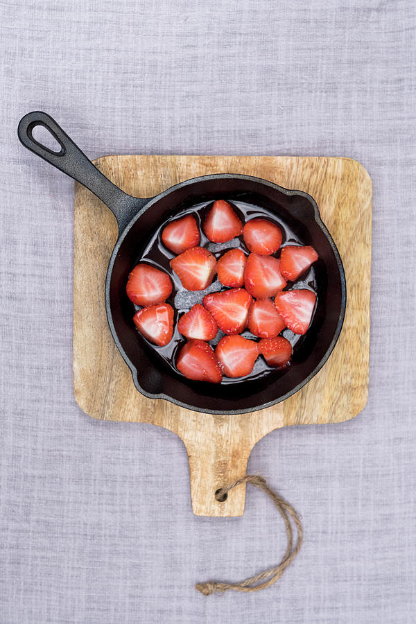 Strawberries Baked In Sugar On The Bbq In A Black Pan, At A Wooden Plank At Linen Photograph by Lucie Beck