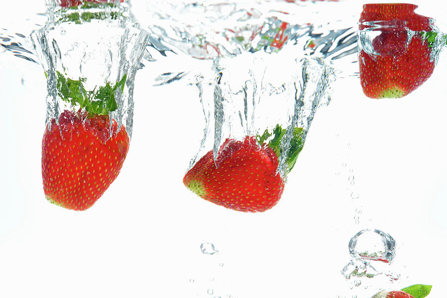 Strawberries Dropping Into Water Photograph by Sami Sarkis