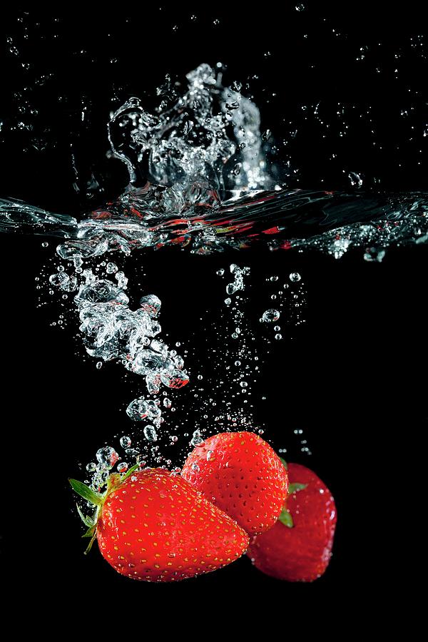 Strawberries Falling In Water With A Splash Photograph by Tom Regester