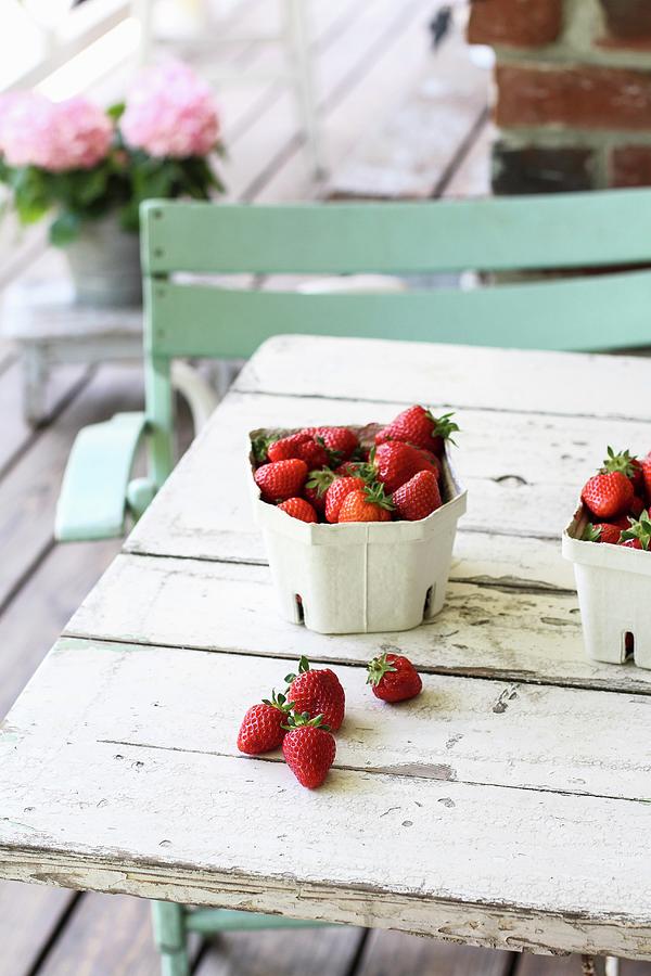 Strawberries In A Cardboard Bowl On A Terrace Table Photograph by Dees Kche
