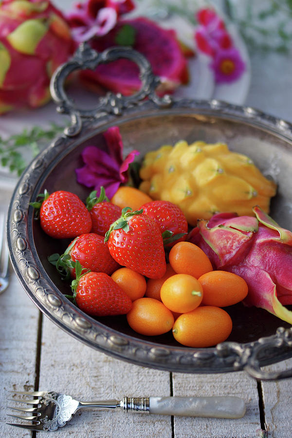 Strawberries, Kumquats And Dragon Fruit In A Elegant Fruit Bowl Photograph by Angelica Linnhoff
